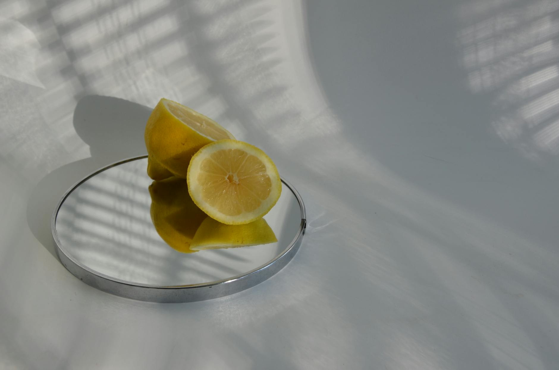 A hand reaching for a colorful lemon vibrator among other intimacy devices on a table