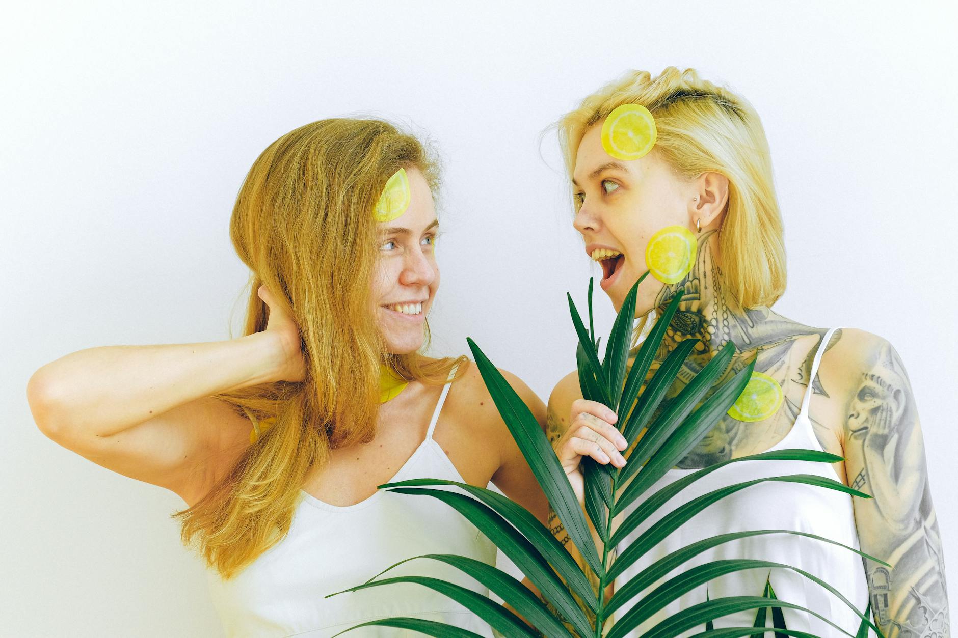 Two women smiling together indoors, expressing joy and comfort in a modern space.