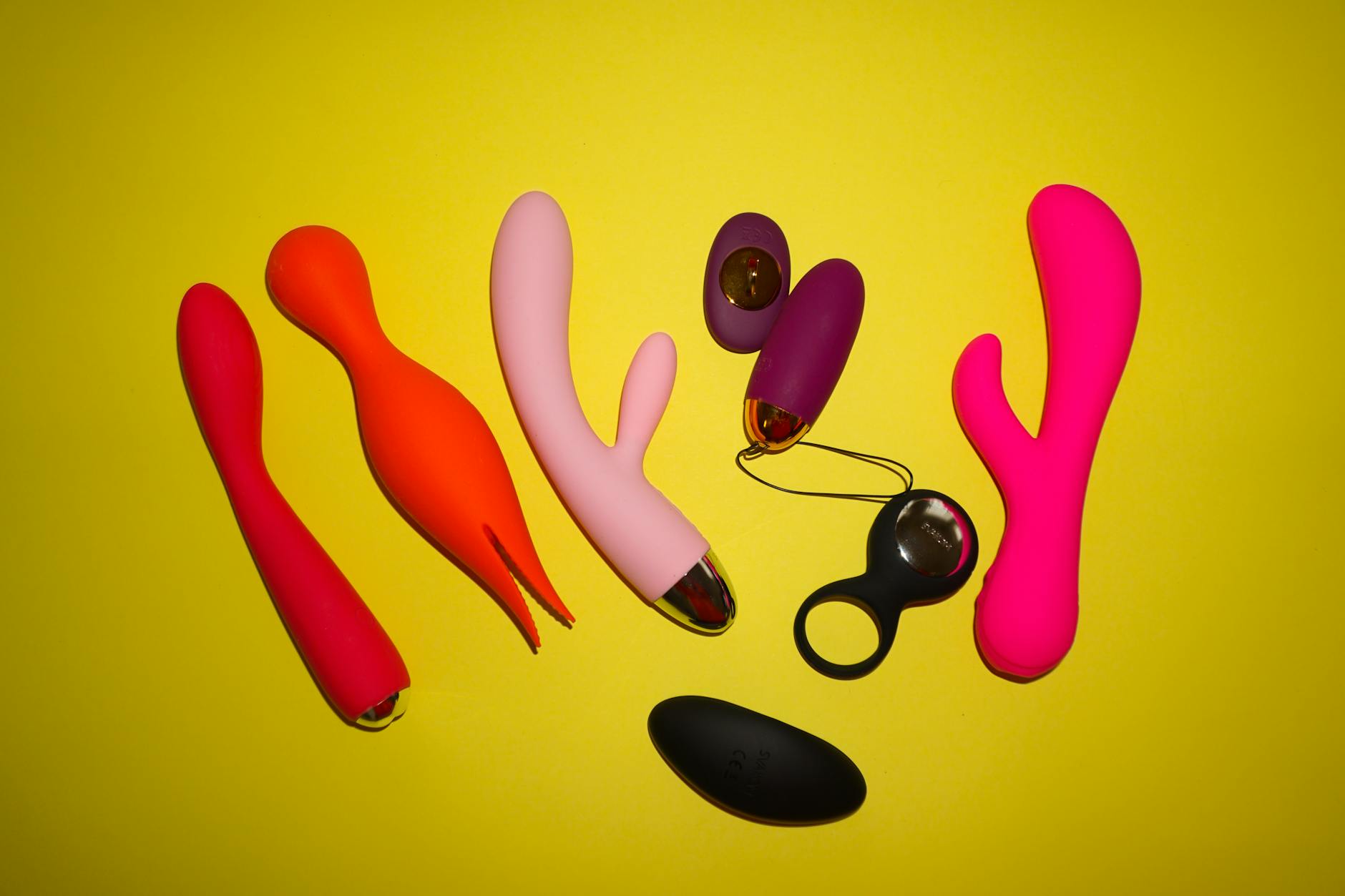 Bright ripe lemons arranged on a yellow background in studio lighting, representing the lemon vibrator design